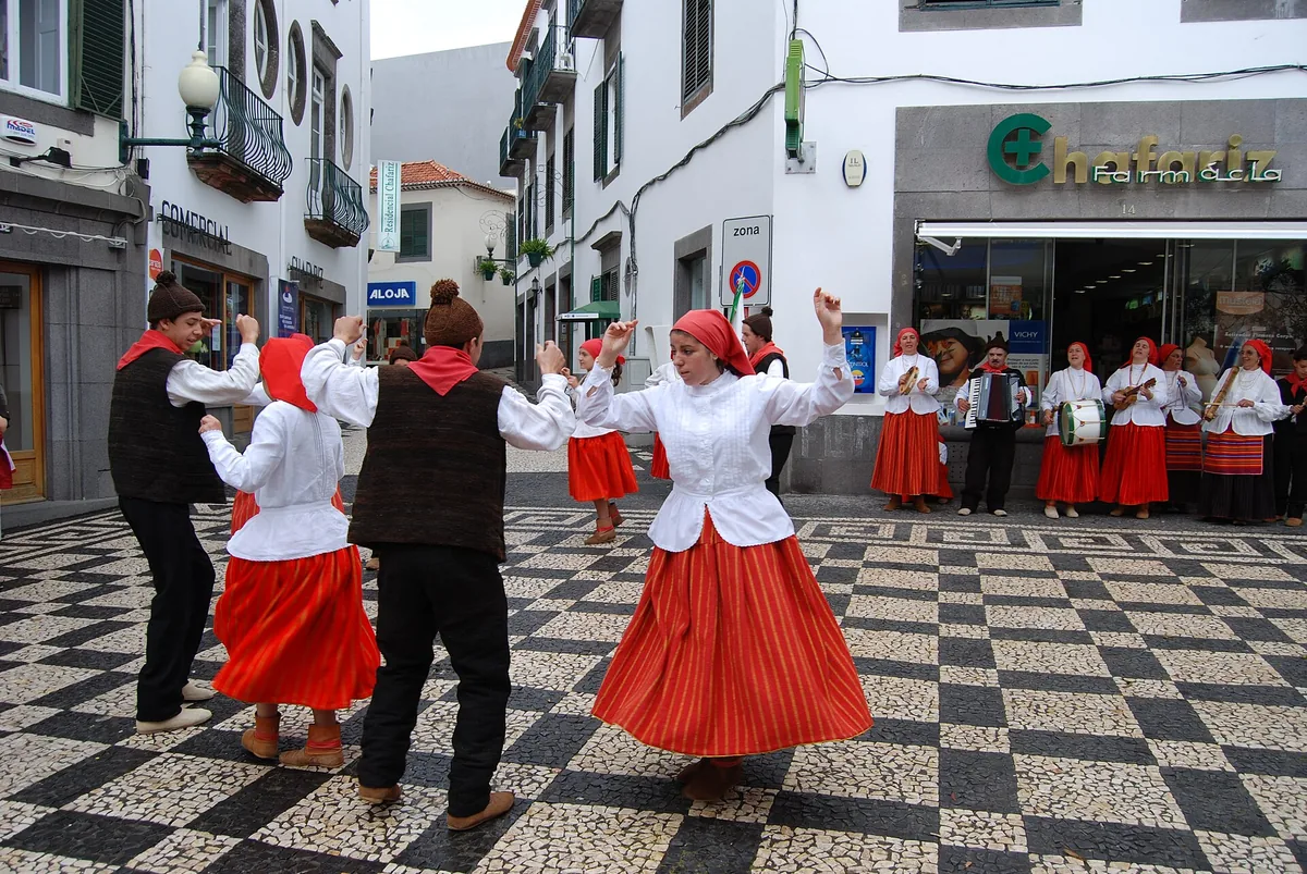 Dancers in traditional Madeiran costume performing in a street in Funchal during the Flower Festival